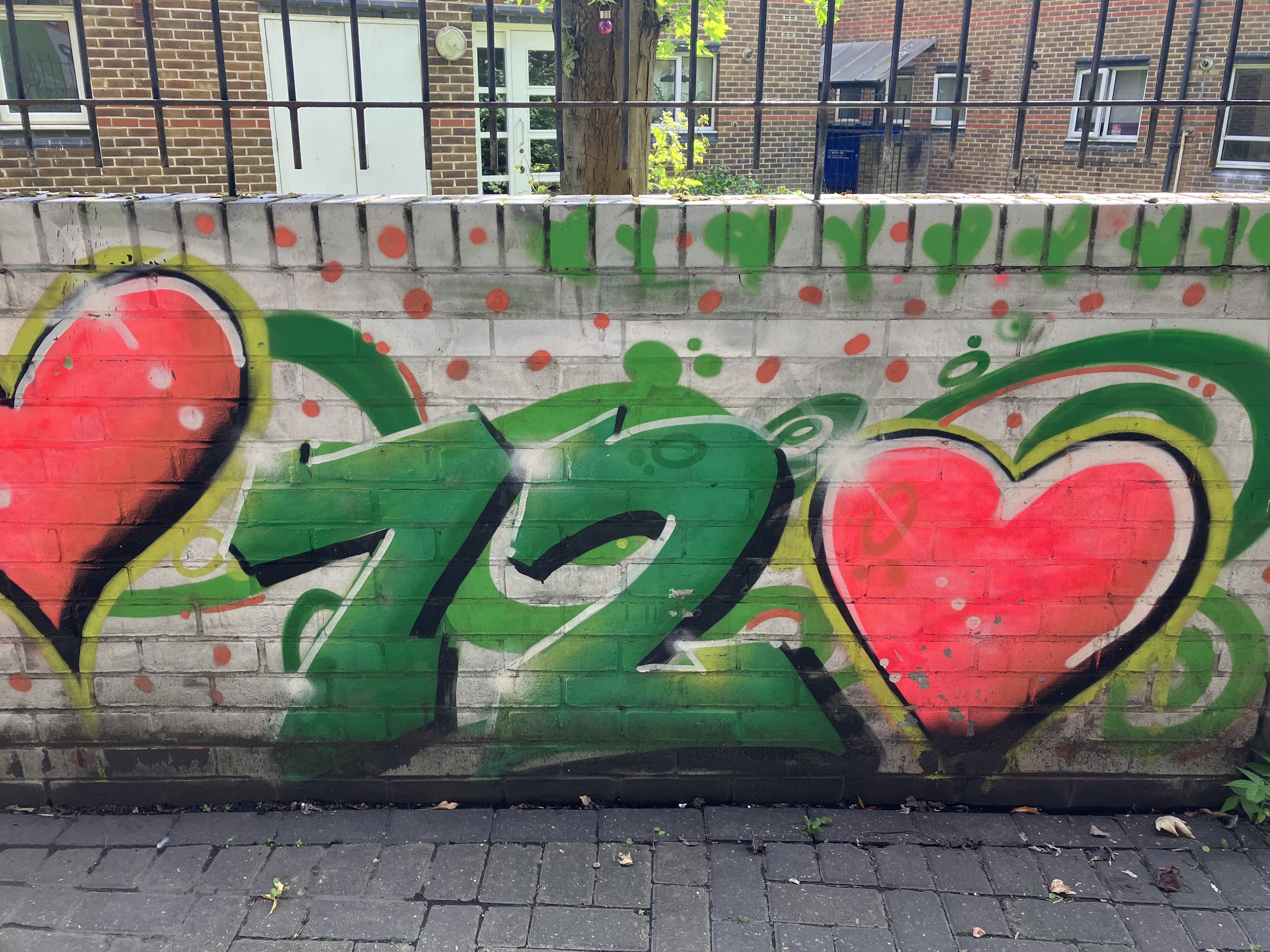 The number 72 written in graffiti on a wall in North Kensington